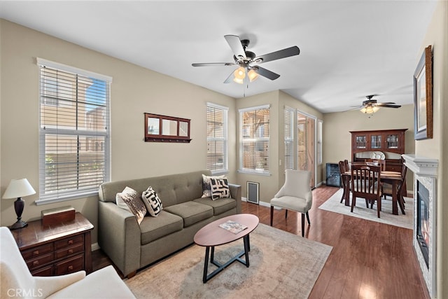 81 Mercantile Way, Ladera Ranch, CA 92694 - living room featuring ceiling fan, dark wood-style flooring, and a glass covered fireplace