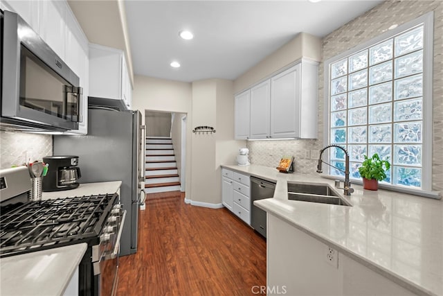 81 Mercantile Way, Ladera Ranch, CA 92694 - kitchen featuring stainless steel appliances, white cabinetry, dark wood-style flooring, healthy amount of natural light, and recessed lighting
