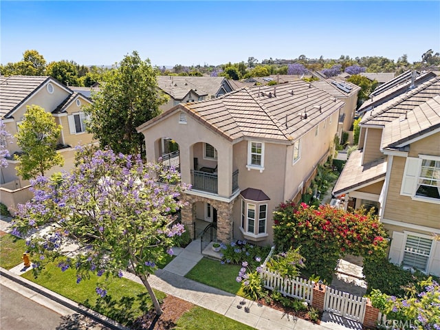 81 Mercantile Way, Ladera Ranch, CA 92694 - view of front of home with a balcony, stucco siding, a tiled roof, and a residential view