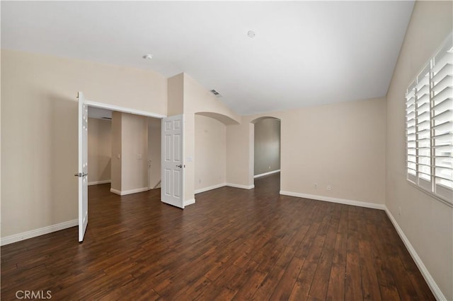 35459 Azalea Cir, Winchester, CA 92596 - empty room with lofted ceiling, dark wood-type flooring, and arched walkways
