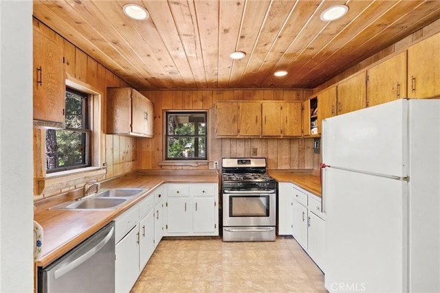 26251 Alpine Ln, Twin Peaks, CA 92391 - kitchen featuring appliances with stainless steel finishes, wood ceiling, recessed lighting, wooden walls, and light countertops