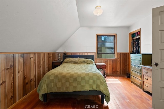 26251 Alpine Ln, Twin Peaks, CA 92391 - bedroom with light wood-type flooring, wainscoting, wood walls, and lofted ceiling