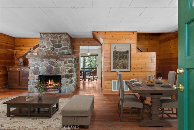 26251 Alpine Ln, Twin Peaks, CA 92391 - living room featuring wooden walls, wood finished floors, and a stone fireplace