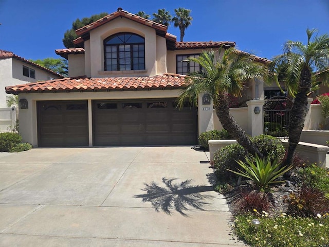 4970 Beauchamp Ct, San Diego, CA 92130 - mediterranean / spanish home with driveway, stucco siding, a tile roof, and an attached garage