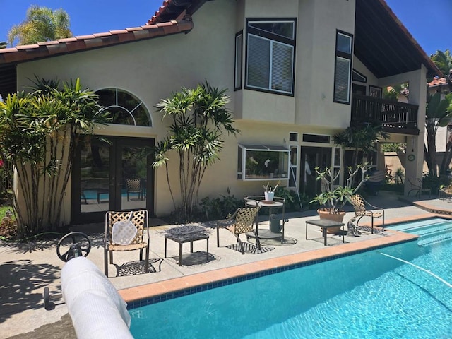 4970 Beauchamp Ct, San Diego, CA 92130 - back of house featuring a balcony, stucco siding, french doors, and a patio