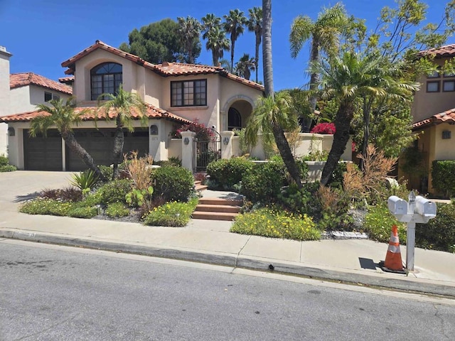 4970 Beauchamp Ct, San Diego, CA 92130 - mediterranean / spanish-style home with a tiled roof, stucco siding, an attached garage, and concrete driveway