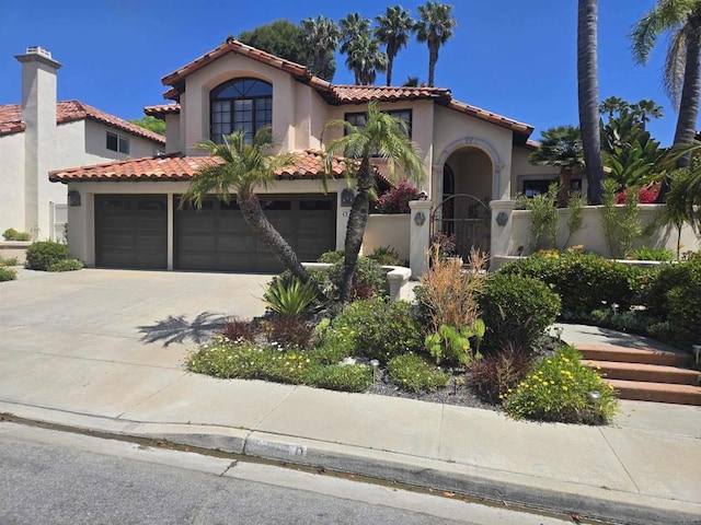 4970 Beauchamp Ct, San Diego, CA 92130 - mediterranean / spanish-style house featuring stucco siding, a tile roof, driveway, and an attached garage