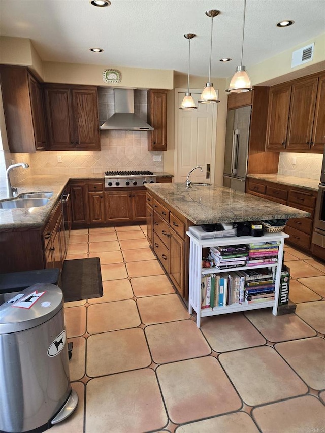 4970 Beauchamp Ct, San Diego, CA 92130 - kitchen with wall chimney range hood, appliances with stainless steel finishes, tasteful backsplash, light stone countertops, and an island with sink