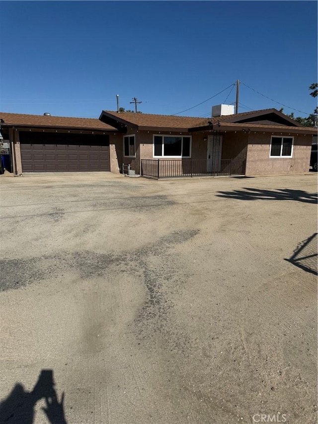 7395 Sage Ave, Yucca Valley, CA 92284 - ranch-style house with an attached garage and driveway