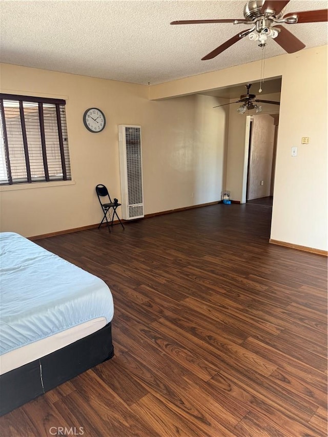 7395 Sage Ave, Yucca Valley, CA 92284 - bedroom featuring a heating unit, wood finished floors, a textured ceiling, and a ceiling fan