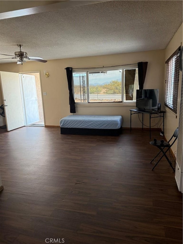 7395 Sage Ave, Yucca Valley, CA 92284 - bedroom featuring wood finished floors, multiple windows, a ceiling fan, and a textured ceiling