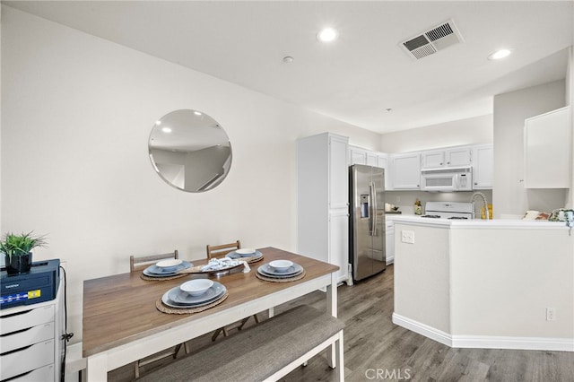 811 Larkridge, Irvine, CA 92618 - kitchen featuring white microwave, stainless steel refrigerator with ice dispenser, light wood-style floors, stove, and recessed lighting