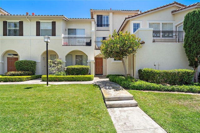 811 Larkridge, Irvine, CA 92618 - view of front facade with stucco siding, a front yard, and a tile roof