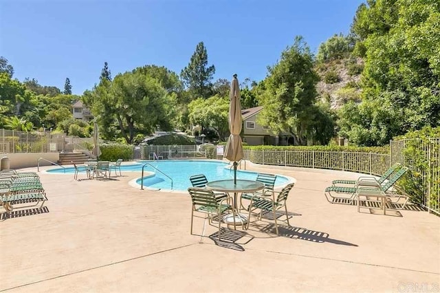 5983 Gaines St, San Diego, CA 92110 - community pool featuring a patio area and view of wooded area