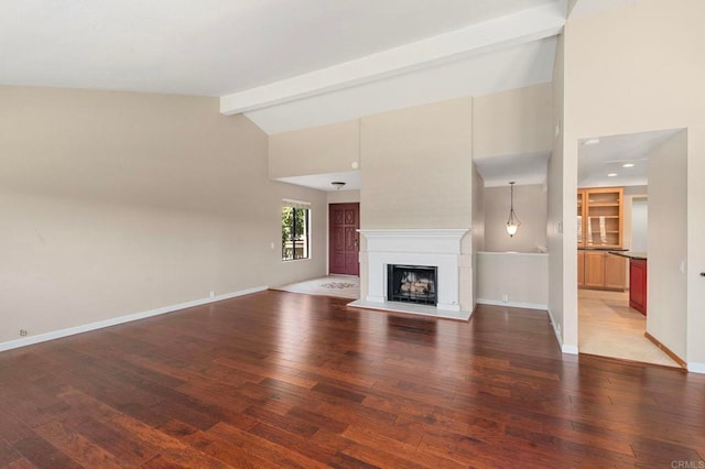 5983 Gaines St, San Diego, CA 92110 - unfurnished living room featuring wood finished floors, beamed ceiling, a fireplace with raised hearth, and high vaulted ceiling
