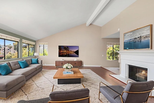 5983 Gaines St, San Diego, CA 92110 - living room with wood finished floors, beamed ceiling, a glass covered fireplace, and high vaulted ceiling
