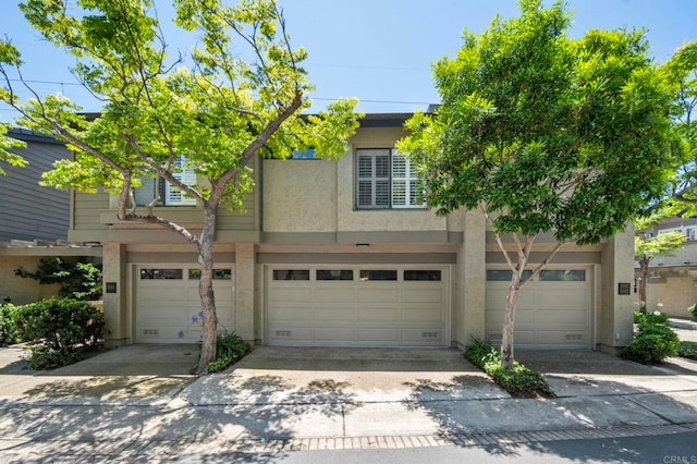 5983 Gaines St, San Diego, CA 92110 - townhome / multi-family property with a garage, stucco siding, and concrete driveway