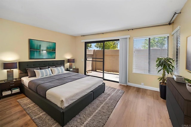 5983 Gaines St, San Diego, CA 92110 - bedroom with access to outside and wood finished floors