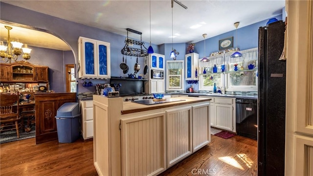 24083 Cresta Dr, Crestline, CA 92325 - kitchen featuring black appliances, dark wood-style floors, a chandelier, and hanging light fixtures