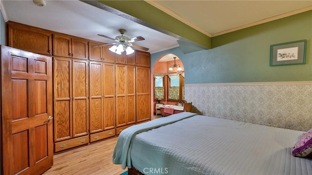 24083 Cresta Dr, Crestline, CA 92325 - bedroom with light wood-style flooring, wainscoting, ornamental molding, and wallpapered walls