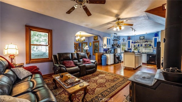 24083 Cresta Dr, Crestline, CA 92325 - living room featuring ceiling fan, arched walkways, wood finished floors, and a chandelier