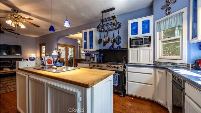 24083 Cresta Dr, Crestline, CA 92325 - kitchen with wood counters, appliances with stainless steel finishes, arched walkways, a ceiling fan, and dark wood-style floors