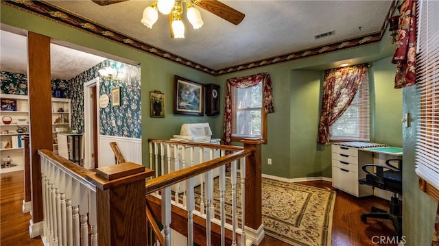 24083 Cresta Dr, Crestline, CA 92325 - hall featuring an upstairs landing, wood finished floors, a textured ceiling, and wainscoting