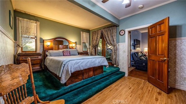 24083 Cresta Dr, Crestline, CA 92325 - bedroom with wood finished floors, crown molding, ceiling fan, and wainscoting