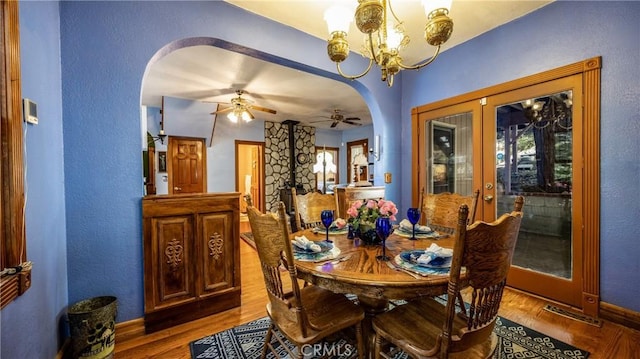 24083 Cresta Dr, Crestline, CA 92325 - dining room featuring arched walkways, a chandelier, wood finished floors, ceiling fan, and a textured wall