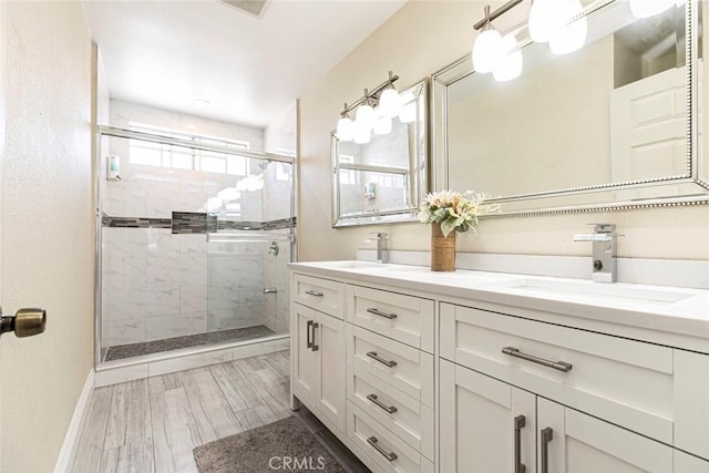 15521 Sandra Ln, Sylmar, CA 91342 - full bathroom with double vanity, a stall shower, and wood finished floors