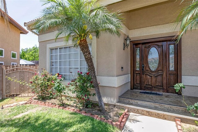 15521 Sandra Ln, Sylmar, CA 91342 - doorway to property featuring stucco siding and a gate