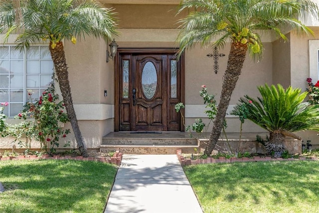 15521 Sandra Ln, Sylmar, CA 91342 - doorway to property featuring stucco siding and a yard
