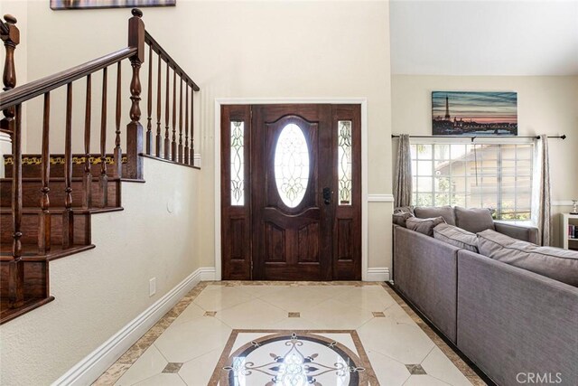 15521 Sandra Ln, Sylmar, CA 91342 - foyer entrance featuring light tile patterned floors, a towering ceiling, and stairway