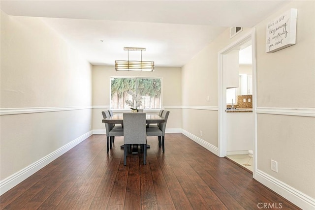 15521 Sandra Ln, Sylmar, CA 91342 - dining room featuring dark wood-style flooring and baseboards
