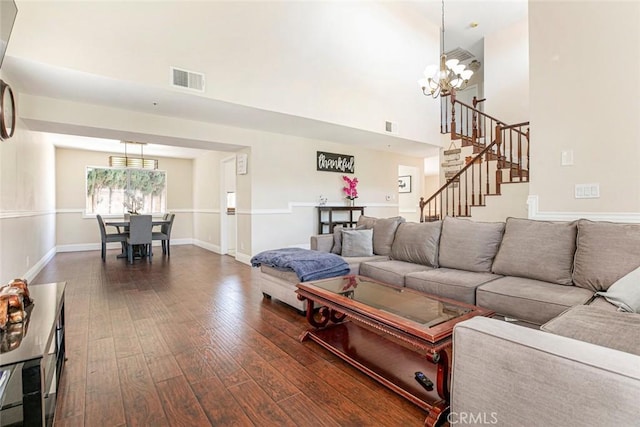 15521 Sandra Ln, Sylmar, CA 91342 - living area featuring a chandelier, dark wood-type flooring, stairs, and a towering ceiling