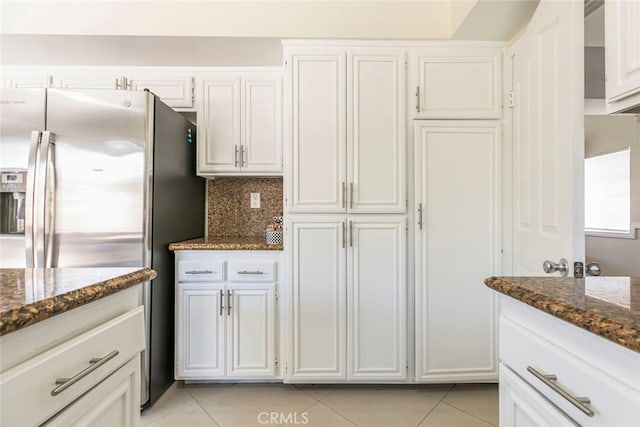 15521 Sandra Ln, Sylmar, CA 91342 - kitchen featuring light tile patterned flooring, dark stone counters, and white cabinetry
