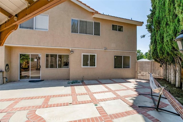 15521 Sandra Ln, Sylmar, CA 91342 - rear view of house featuring stucco siding and a patio area