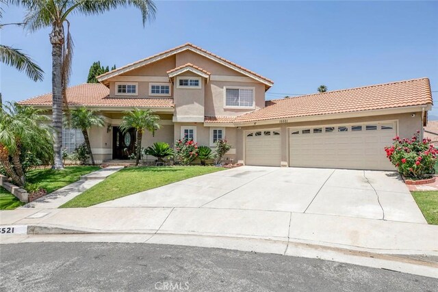 15521 Sandra Ln, Sylmar, CA 91342 - view of front of house featuring a garage, a tile roof, stucco siding, driveway, and a front yard
