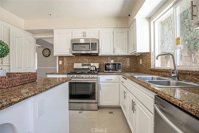 15521 Sandra Ln, Sylmar, CA 91342 - kitchen featuring stainless steel appliances, healthy amount of natural light, and white cabinets