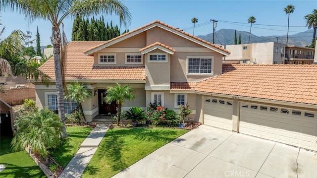 15521 Sandra Ln, Sylmar, CA 91342 - view of front facade featuring a tiled roof, a mountain view, driveway, stucco siding, and a front lawn