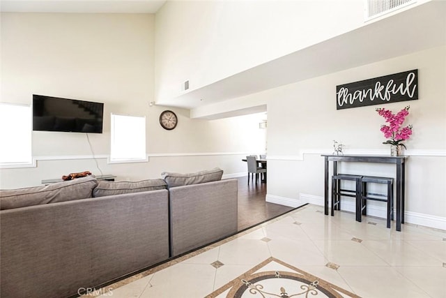 15521 Sandra Ln, Sylmar, CA 91342 - tiled living area featuring a high ceiling and baseboards