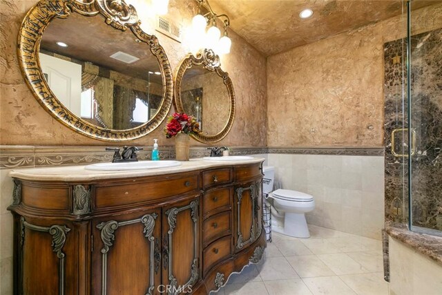 15521 Sandra Ln, Sylmar, CA 91342 - full bath featuring tile walls, double vanity, a shower with shower door, a wainscoted wall, and tile patterned floors