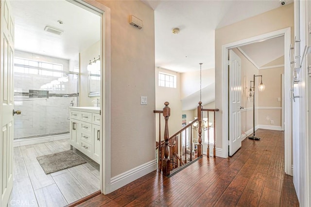 15521 Sandra Ln, Sylmar, CA 91342 - hallway with an upstairs landing and dark wood-style floors
