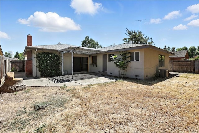 457 Brian Ct, Merced, CA 95348 - rear view of property featuring a patio area, a chimney, a fenced backyard, crawl space, and stucco siding