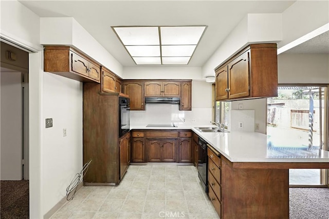 457 Brian Ct, Merced, CA 95348 - kitchen featuring black appliances, a peninsula, under cabinet range hood, and plenty of natural light