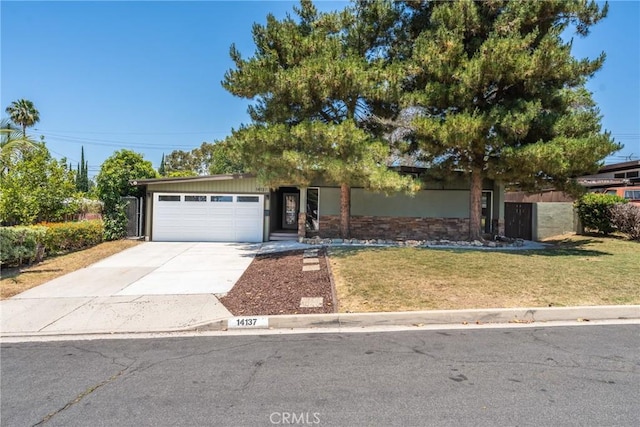 14137 Viburnum Dr, Whittier, CA 90604 - obstructed view of property with concrete driveway, an attached garage, and a front yard