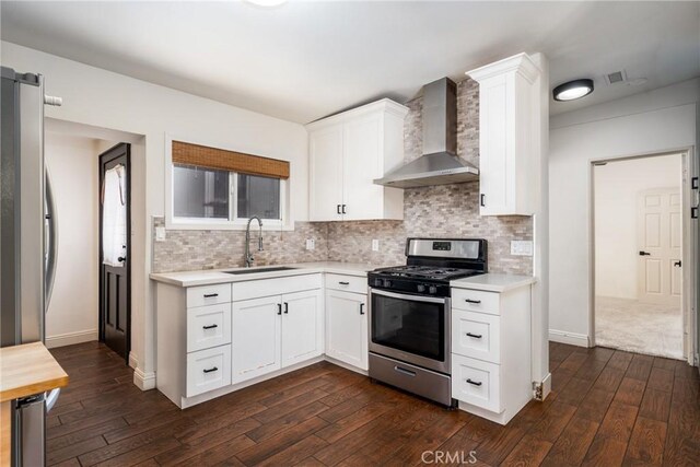 14137 Viburnum Dr, Whittier, CA 90604 - kitchen featuring wall chimney range hood, stainless steel appliances, light countertops, and dark wood-type flooring