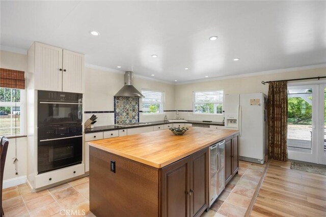 28201 Stallion Springs Dr, Tehachapi, CA 93561 - kitchen featuring white refrigerator with ice dispenser, wall chimney range hood, butcher block counters, stovetop, and a center island