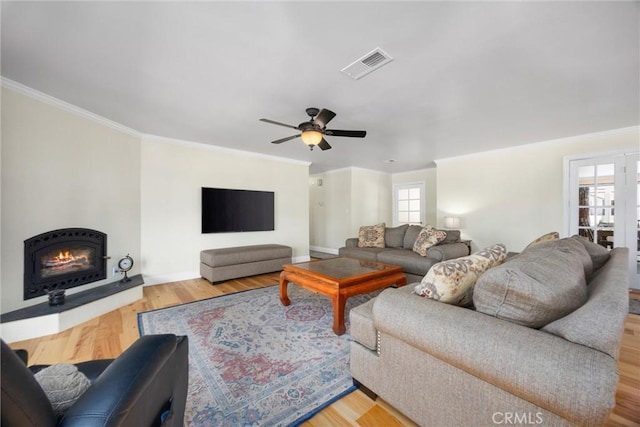 28201 Stallion Springs Dr, Tehachapi, CA 93561 - living area with ornamental molding, wood finished floors, a ceiling fan, and a warm lit fireplace