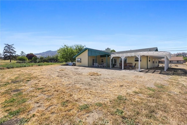 28201 Stallion Springs Dr, Tehachapi, CA 93561 - rear view of house with a patio, a chimney, and a mountain view